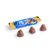 Three pieces of Hazelnut Chocolate Domes with a blue and gold packaging labeled 'Godiva' in the background.